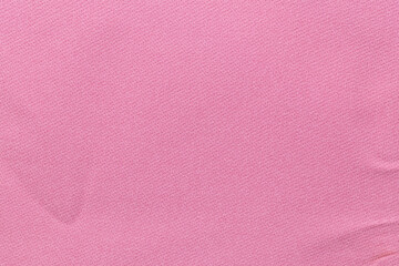 The Pink color fabric cloth with wrinkle texture as background.