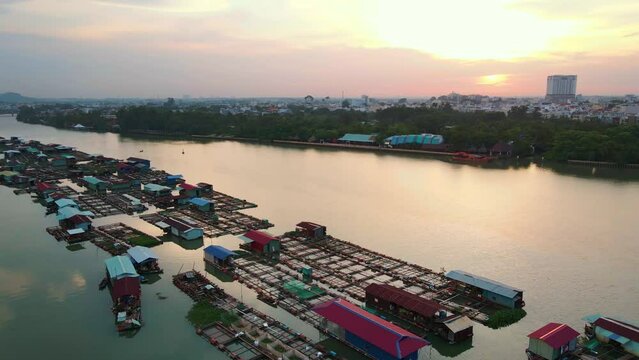 Aerial drone footage of the sea and flooded houses in Vietnam at sunset