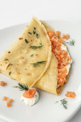 smoked salmon and sour cream crepe pancake on white background