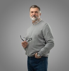 Portrait of happy casual mature man smiling, senior age man with gray hair, Isolated on gray...