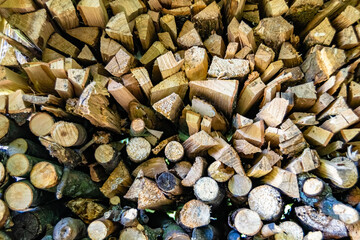 Photography on theme big wall of stacked oak tree logs in cracks
