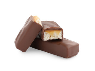Pieces of chocolate bars with caramel on white background