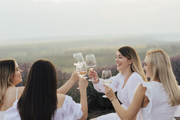 Girlfriends had fun spending time together at summer picnic on the lavender field. 