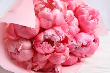Bouquet of beautiful pink peonies on white wooden table, closeup