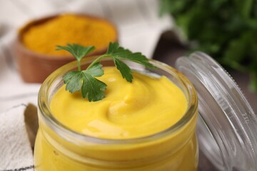 Jar with tasty curry sauce and parsley, closeup