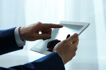 Closeup view of man using new tablet indoors