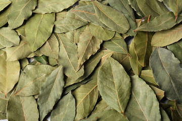 Pile of aromatic bay leaves as background, top view
