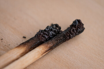 Macro shot of burnt match sticks on a wooden surface