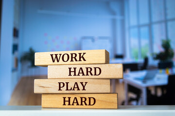 Wooden blocks with words 'WORK HARD PLAY HARD'.