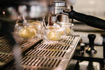 Cafe. A coffee machine that has a glass cup with a scoop of ice cream to make coffee with ice cream