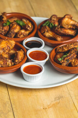 Vertical shot of fried chicken with different sauces