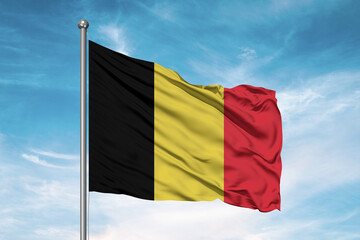 Belgium national flag cloth fabric waving on beautiful sky Background.