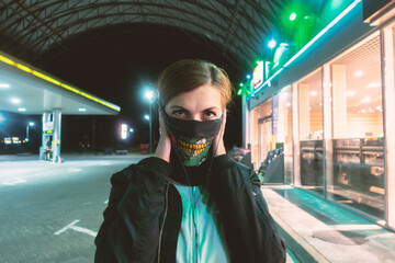 Woman covers rock buff with monster teeth print. woman at the gas station