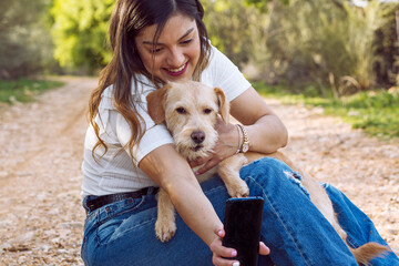 Closeup shot of a young female taking selfies with her retriever
