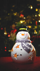 Fototapeta premium Vertical shot of a snowman made from porcelain as decoration for Christmas holidays
