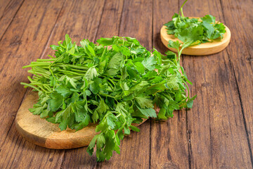 Closeup shot of fresh parsley (Petroselinum crispum) on the wooden trays