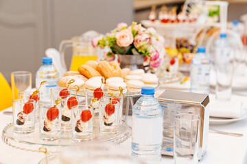 canapes with cherry tomato, mozzarella and olive in cups 