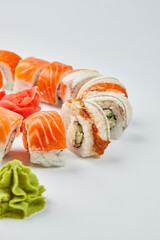 Traditional delicious fresh sushi set Philadelphia roll with salmon, smoked eel and cucumber isolated on white background. Sushi menu. Japanese asian food