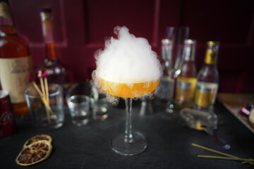 Smoke Bomb: Yellow cocktail, dramatic smoke explosion on top, captivating presentation, close-up, vibrant drink