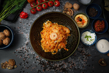 Obraz na płótnie Canvas Delicious Tagliatelle Pasta Dish: Fresh Prawns, Tomato Sauce, Italian Cuisine, Seafood Delight, Homemade Gourmet Meal, Authentic Recipe, Tasty Dinner