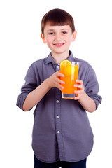 A cute cheerful boy holding a glass of orange juice isolated on transparent background