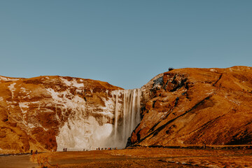 Fototapeta na wymiar Winter raw landscapes in Iceland. The waterfall in a background