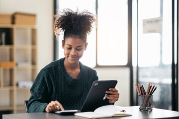 African american student woman in sweater using calculator for d