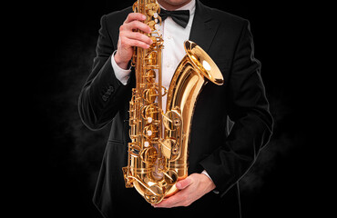 Fototapeta na wymiar Saxophonist on a black background.