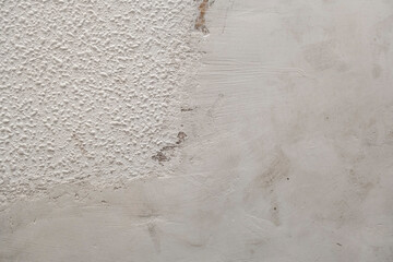 Plaster coating on damaged white stippled wall