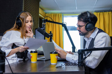 Radio dj talking to a guest in a radio studio