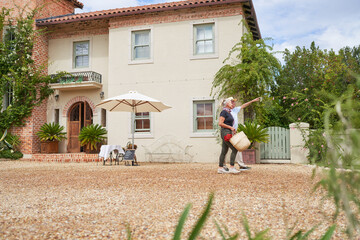 Senior couple talking outside sunny summer villa