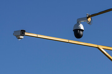 Outdoor surveillance cameras under a blue sky