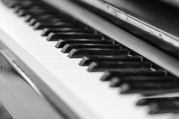 Grayscale closeup shot of the keys of a piano