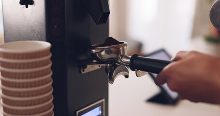 Coffee machine, barista hand and grind beans in cafe, closeup and prepare latte or espresso drink with service. Hot beverage, person working in restaurant and brewing process, premium blend caffeine