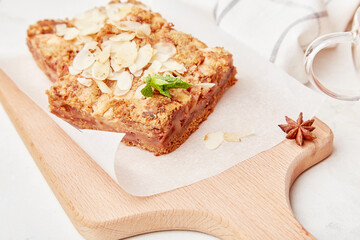 Slices of traditional apple pie with almond flakes close up