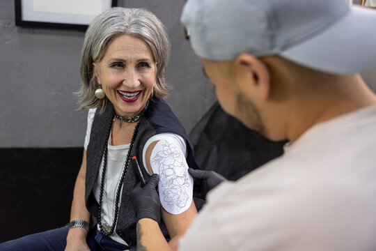 Long-haired woman trying on a skretch for a tattoo