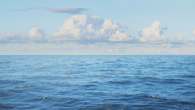 Beautiful view of an ocean on a sunny day under the blue cloudy sky