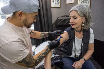 Long-haired woman trying on a skretch for a tattoo