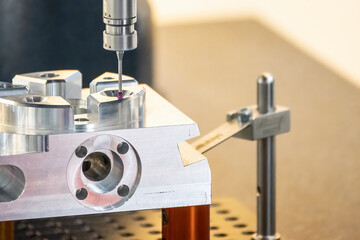Close up scene the multi axis touching probe  measuring the aluminum  parts.