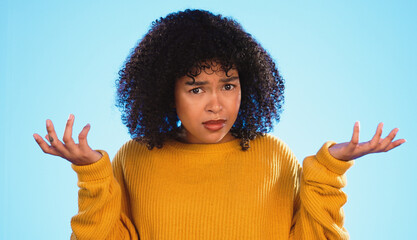 Face, confused and unsure black woman in studio, pensive and dont know gesture on blue background....