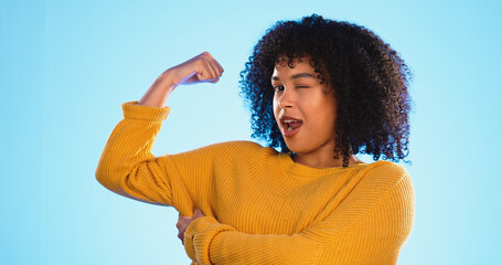 Wink, arm and bicep with a black woman joking in studio on a blue background for fun or humor....