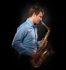 Obraz na płótnie Canvas Saxophonist on a black background close-up.