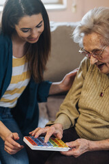 Fototapeta premium Old lady learning about her pill box.