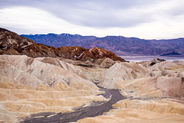 Zabriskie Point. It is a part of the Amargosa Range located east of Death Valley National Park in California, United States. One Man on the Top of Mountain.