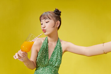 Happy smile asian young woman, girl drinking fresh orange juice in a glass