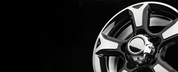 Plakat Beautiful powerful alloy wheels for SUVs close-up on a black background, copy space panoramic