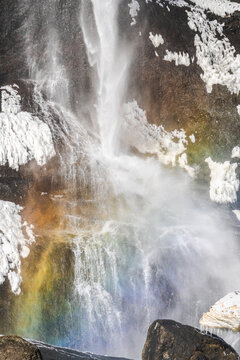 Rainbow near waterfall in nature