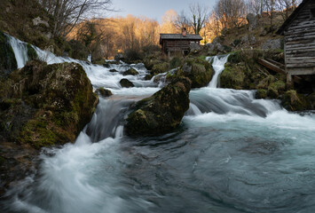 Mountain river with mossy rocks and wooden watermills, river Krupa in Krupa na Vrbasu
