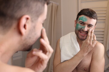 Man using a green beauty face mask 