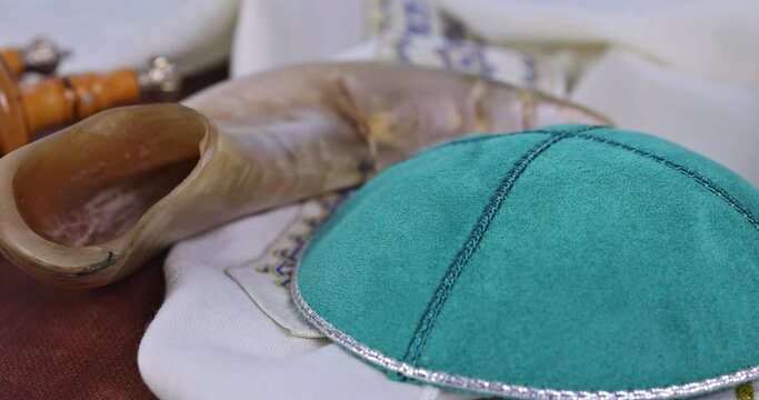 Embrace symbols of prayer associated with Jewish faith, such as torah holy book, shofar horn shawl tallit tefillin